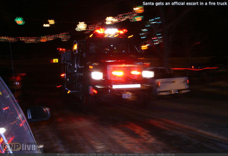 Santa gets an official escort in a fire truck