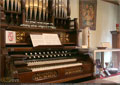 An intact wind organ sits among other religious artifacts