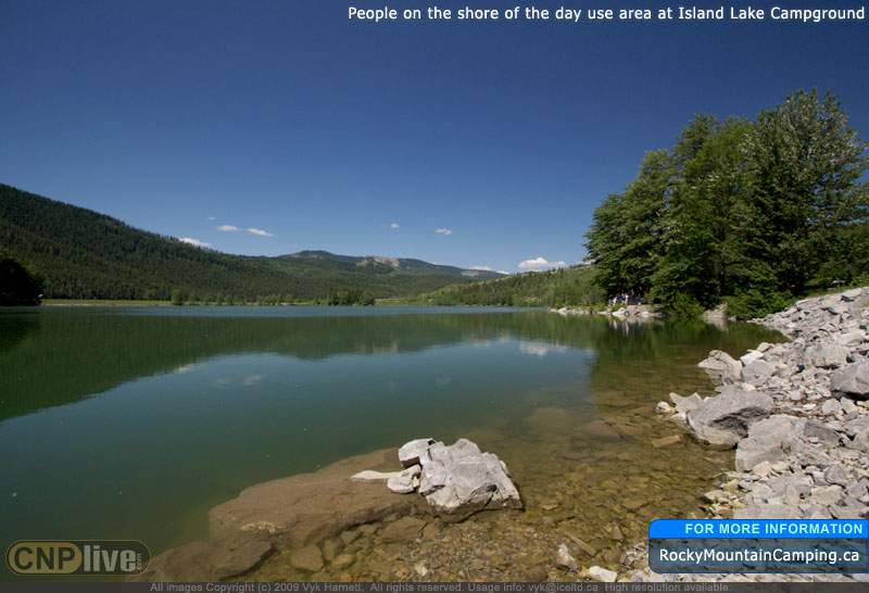 People on the shore of the day-use area at Island Lake Campground